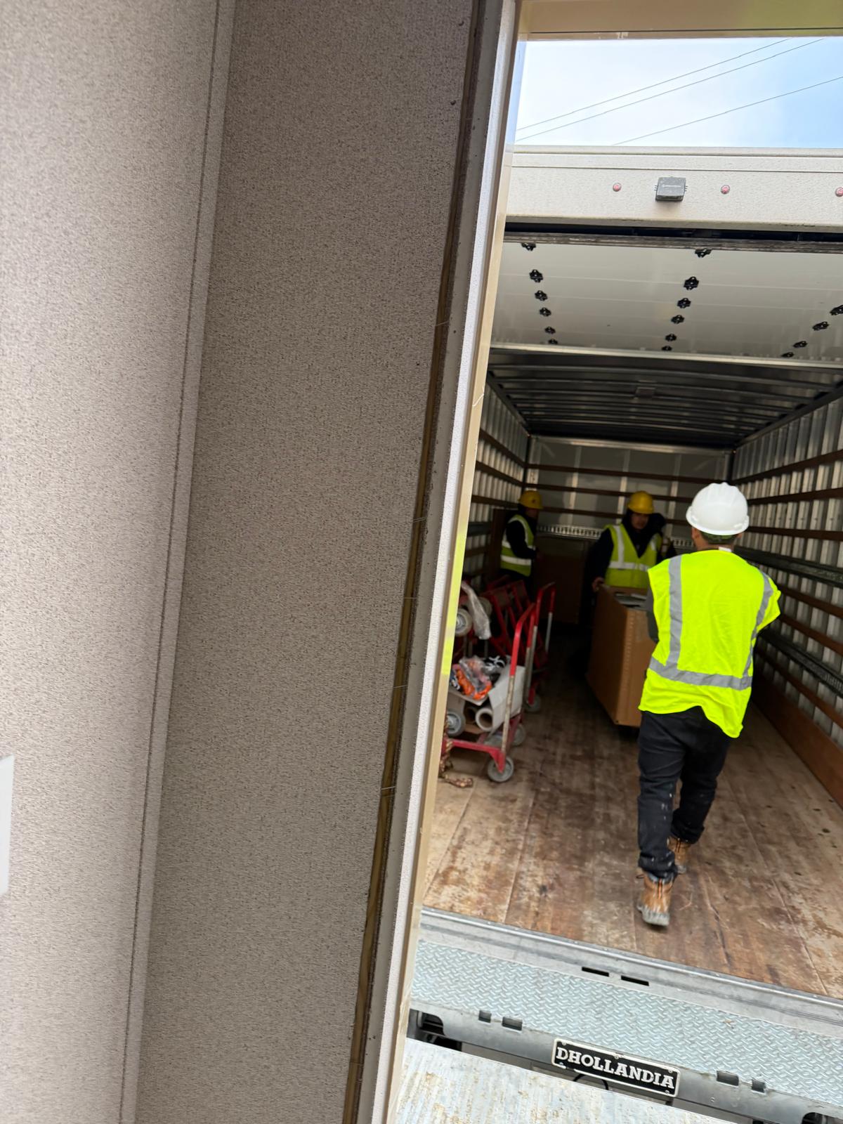 Manova Services moving crew loading equipment into a box truck in New Jersey